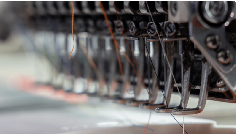 Industrial embroidery production equipment for corporate apparel programs